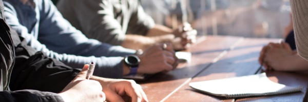 hands at boardroom table